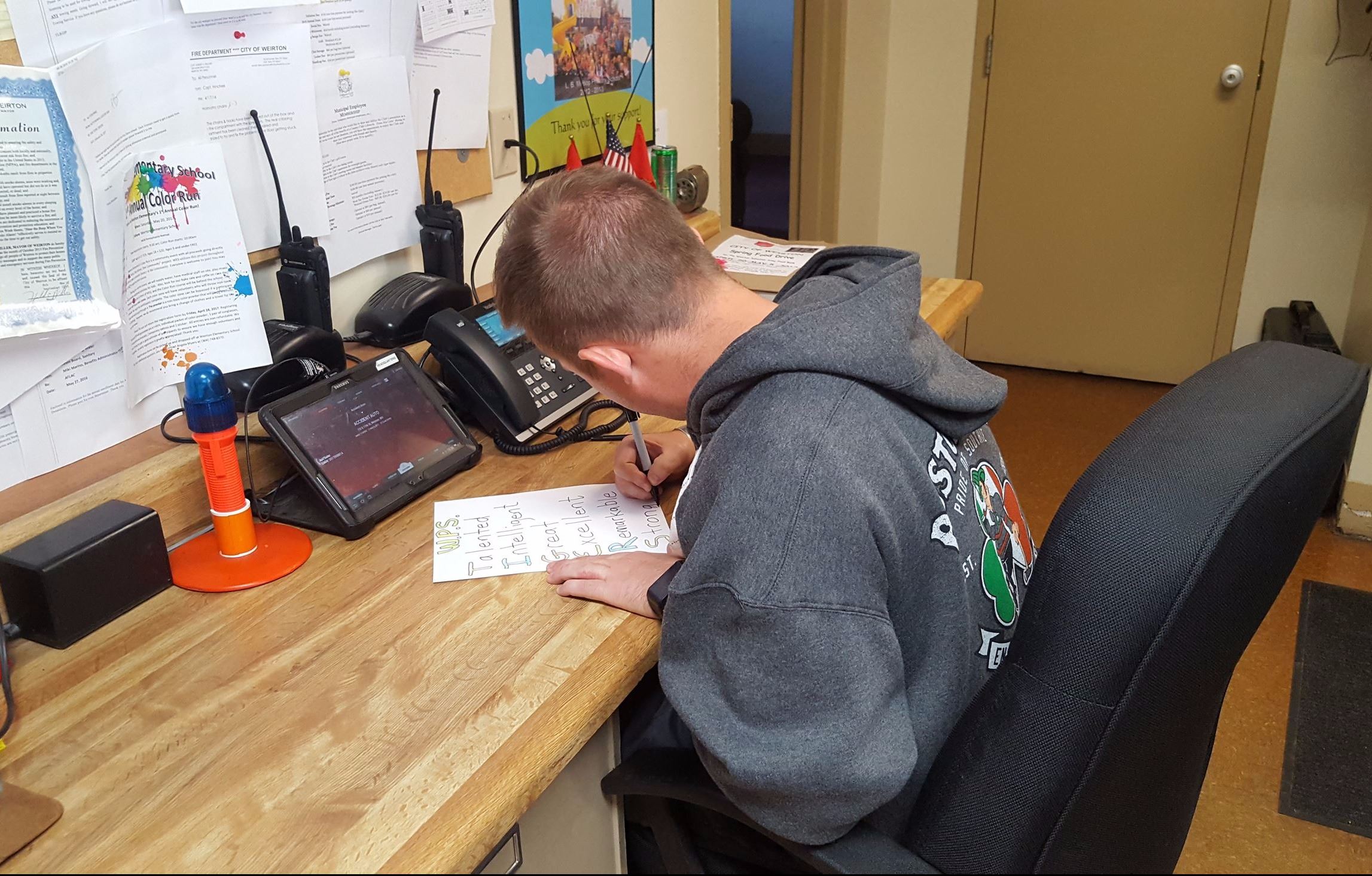 Weirton firefighter Brandon Scott works on an Acrostic Poem for the FF Pen Pal Club