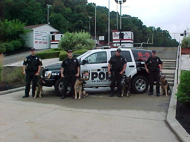 The Weirton K9 Unit in front of a patrol SUV.